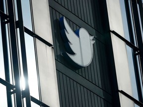 FILE - A Twitter logo hangs outside the company's offices in San Francisco, on Dec. 19, 2022. Russia, China and Iran are exploiting recent changes at Twitter to spread disinformation faster and farther. Under new owner Elon Musk, Twitter recently ended its policy of labeling foreign propaganda agencies like RT or Sputnik.