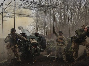 Ukrainian soldiers fire howitzer D-30 at the frontline near Bakhmut, Donetsk region, Ukraine, Wednesday, April 19, 2023.