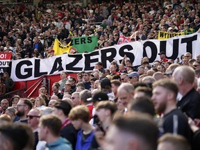 A banner writing ' Glazers out' is displayed by spectators during the English Premier League soccer match between Manchester United and Everton, at the Old Trafford stadium in Manchester, England, Saturday, April 8, 2023.