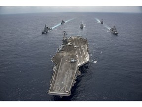 PHILIPPINE SEA - APRIL 28: In this handout photo provided by the U.S. Navy, the Nimitz-class aircraft carrier USS Carl Vinson (CVN 70) leads the Japan Maritime Self-Defense Force destroyers JS Ashigara (DDG 178), left front, and JS Samidare (DD 106), left rear, the Arleigh Burke-class guided-missile destroyers USS Michael Murphy (DDG 112), center rear, and USS Wayne E. Meyer (DDG 108), right rear, and the Ticonderoga-class guided-missile cruiser USS Lake Champlain (CG 57), right front, during a transit the Philippine Sea.