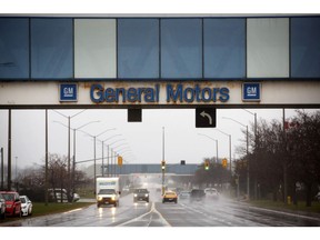 Signage is displayed on a pedestrian bridge near the General Motors Co. Oshawa assembly plant in Oshawa, Ontario, Canada, on Monday, Nov. 26, 2018. General Motors Co. said it will cut more than 10,000 salaried staff and factory workers and close five factories in North America by the end of next year, part of a sweeping realignment to prepare for a future with a greater number of purely electric vehicles.