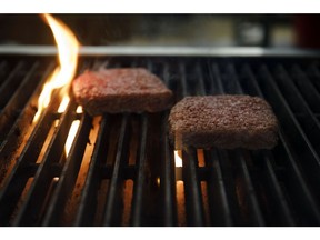 Impossible Burger plant based meat cooks on a grill during the Impossible Foods Inc. grocery store product launch in Los Angeles, California, U.S., on Friday, Sept. 20, 2019. The Impossible Burger made its retail debut at 27 Gelson's Markets locations in Southern California before expanding its retail presence in the fourth quarter and in early 2020, the company said in a statement. Photographer: Patrick T. Fallon/Bloomberg