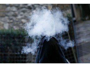 A pedestrian stands surrounded in a cloud of vapour after exhaling from a vape device in London, U.K., on Thursday, Oct. 17, 2019. Vaping has helped tens of thousands of Britons quit smoking each year, a study showed, underlining the U.K.'s more tolerant stance on the alternative to cigarettes as a backlash grows in the U.S. Photographer: Hollie Adams/Bloomberg