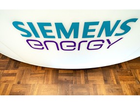 The branding of Siemens Energy AG decorates trading booths on the day of its listing at the Frankfurt Stock Exchange, operated by Deutsche Boerse AG, in Frankfurt, Germany, on Monday, Sept. 28, 2020. Siemens Energy is mulling 300 million euros ($359 million) in additional cost savings over the next three years as the Siemens AG spinoff seeks to improve earnings. Photographer: Thorsten Wagner/Bloomberg