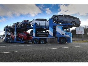 A vehicle transporter leaves the Vauxhall plant in Ellesmere Port, U.K. Photographer: Anthony Devlin/Bloomberg
