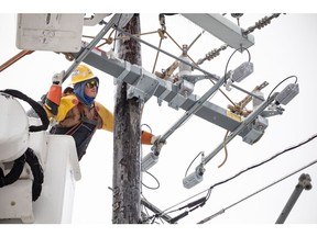 A worker repairs a power line in Austin, Texas, U.S., on Thursday, Feb. 18, 2021. Texas is restricting the flow of natural gas across state lines in an extraordinary move that some are calling a violation of the U.S. Constitution's commerce clause.