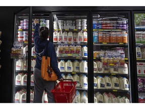 A shopper reaches for cottage cheese inside a grocery store in San Francisco, California, U.S., on Monday, May 2, 2022. U.S. inflation-adjusted consumer spending rose in March despite intense price pressures, indicating households still have solid appetites and wherewithal for shopping. Photographer: David Paul Morris/Bloomberg