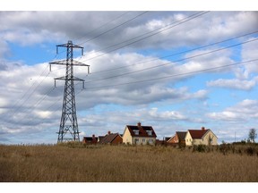 An electricity transmission tower near a new build residential housing estate in Rayleigh, UK, on Monday, July 4, 2022. The UK is set to water down one of its key climate change policies as it battles soaring energy prices that have contributed to a cost-of-living crisis for millions of consumers.