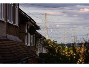 Electricity transmission towers near to residential houses in Upminster, UK, on Monday, July 4, 2022. The UK is set to water down one of its key climate change policies as it battles soaring energy prices that have contributed to a cost-of-living crisis for millions of consumers.