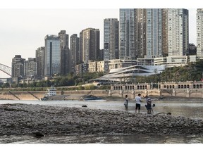 People near the shallow banks of Yangtze River, due to low water levels caused by drought, in Chongqing in 2022. Photographer: Qilai Shen/Bloomberg