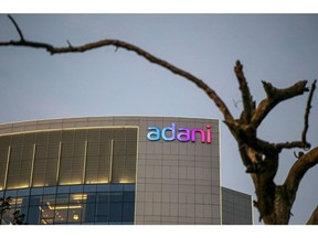 Signage atop the Adani Group headquarters in Ahmedabad, India, on Wednesday, Feb. 1, 2023. Bonds of the Indian billionaire's flagship firm plunged to distressed levels in US trading, and the company abruptly pulled a record domestic stock offering after the Adani group suffered a $92 billion market crash.