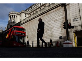 City workers pass the Bank of England (BOE) during lunchtime on the day of a train drivers strike in London, UK, on Friday, Feb. 3, 2023. Strikes are estimated to have cost the UK economy £1.5 billion ($1.85 billion) last year, according to Bloomberg Economics. Photographer: Carlos Jasso/Bloomberg