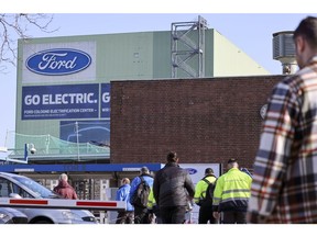 Employees arrive for work at the Ford Motor Co. plant in Cologne, Germany, on Tuesday, Feb. 14, 2023. Ford will dismiss some 11% of its workforce in Europe in the latest sign of industrial disruption caused by the automotive sector's shift to electric vehicles.