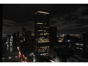 Partially lit office buildings on the city skyline during a loadshedding power outage period, in Johannesburg, South Africa. Photographer: Leon Sadiki/Bloomberg