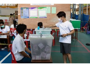 A voter casts his ballot at a polling station in the Phrom Phong area of Bangkok, Thailand, on Sunday, May 14, 2023. A record number of Thais are projected to go to the ballot boxes in Sunday's parliamentary election as voters decide if they'll shift leadership away from almost a decade of military-backed rule. More than 50 million Thais are eligible to vote, and the Election Commission expects an 80% turnout. Photographer: Luke Duggleby/Bloomberg