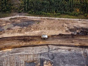 A heavy hauler truck drives through the Albian Sands Energy Inc. Muskeg River mine in this aerial photograph taken above the Athabasca oilsands near Fort McMurray.