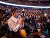 A woman takes a picture at the Berkshire Hathaway AGM