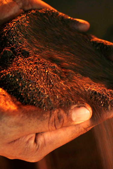 Processed nickel runs through a person's hands