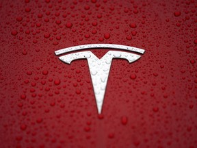 A Tesla logo on a car in China.