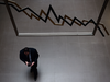 Man walking under financial markets sign