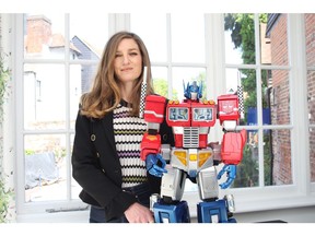 Clare Foltynie, Co-founder of Agora Models with their Big-Scale-Model of Optimus Prime. This model kit is the latest launch from Agora Models, measuring 78cm (2 1/2 ft) tall and composed of over 600 carefully engineered die-cast pieces, with electronics that include a faceplate that moves in sync to speech and on-body lighting. This model is fully articulated allowing it to be posed in myriad ways to re-enact the heroic poses from the TV series from our childhood.