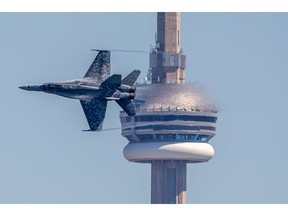 A CF-18 jet flying by Toronto's CN Tower from 2022's air show.