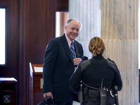Steve Ricchetti, one of the top negotiators for President Joe Biden on the debt limit crisis, is greeted by a Capitol Police office after he passed through security to return to closed-door mediation, at the Capitol in Washington, Tuesday, May 23, 2023.