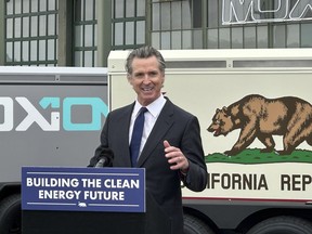 California Gov. Gavin Newsom speaks during a news conference, Thursday, May 25, 2023, in Richmond, California. Newsom updated his plan for the state to move away from fossil fuels. State regulators say California is unlikely to have an electricity shortage this summer.