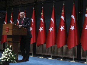 FILE - Turkey's President Recep Tayyip Erdogan speaks after he signed a decision confirming the election date, in Ankara, Turkey, Friday, March 10, 2023. Turkish President Recep Tayyip Erdogan says Russia has agreed to extend a deal that has allowed Ukraine to ship grain through the Black Sea to parts of the world struggling with hunger. Erdogan said Wednesday that the deal would be extended for two months.
