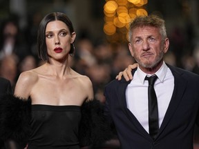 EDS NOTE: NUDITY - Raquel Nave, left, and Sean Penn pose for photographers upon arrival at the premiere of the film 'Black Flies' at the 76th international film festival, Cannes, southern France, Thursday, May 18, 2023.