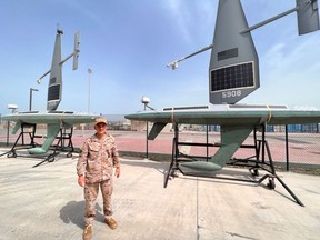 Spanish Navy Commander Jorge Lens with Saildrone Explorer solar and hydro USVs at the US naval base in Bahrain.