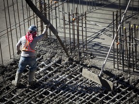 A contractor pours cement into the base of a condominium under construction in downtown Vancouver.