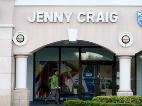 A person walks past a Jenny Craig weight loss store in Miami, Florida.