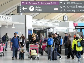 People are shown at Pearson International Airport in Toronto on Friday, March 10, 2023.