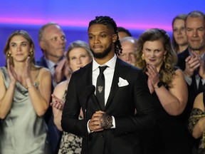 FILE - Buffalo Bills' Damar Hamlin speaks in front of University of Cincinnati Medical Center staff during the NFL Honors award show ahead of the Super Bowl 57 football game, Thursday, Feb. 9, 2023, in Phoenix. Damar Hamlin will put the $9.1 million given to a GoFundMe campaign by well-wishers after his on-field collapse into his own nonprofit, the Chasing M's Foundation. The decision, first shared with The Associated Press Monday, May 8, 2023, is a first step in the 25-year-old's plan for the unprecedented outpouring of support that he received after his heart stopped following a tackle during a Monday night football game in January.