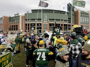 Fans tailgate outside Lambeau Field before an NFL football game between the Dallas Cowboys and the Green Bay Packers, Nov. 13, 2022, in Green Bay, Wis. The NFL draft will be coming to Green Bay and historic Lambeau Field in 2025. NFL officials announced Monday, May 22, 2023, during the league's spring meetings that the 2025 draft will take place in Green Bay. Activities will go on inside and around field and Titletown, the collection of shops and restaurants surrounding the stadium.