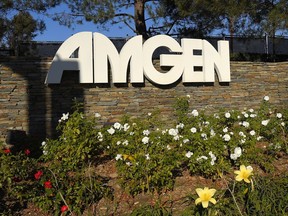 FILE - This photo shows signage outside the Amgen headquarters in Thousand Oaks, Calif on Nov. 9, 2014. Federal regulators are suing to block biotech drug developer Amgen's more than $26 billion deal for Horizon Therapeutics. The Federal Trade Commission said Tuesday, May 16, 2023, that the deal, announced last December, would give Amgen unfair leverage to block competition for Horizon medications.