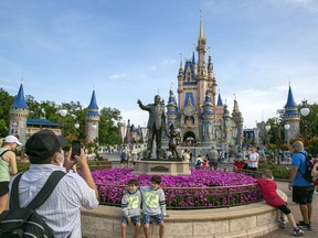 FILE - People visit the Magic Kingdom Park at Walt Disney World Resort in Lake Buena Vista, Fla., April 18, 2022. Ongoing strength at its theme parks and an improving streaming business propelled The Walt Disney Co. to higher profits and revenue in its fiscal second quarter in 2023.