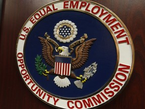 FILE - The emblem of the U.S. Equal Employment Opportunity Commission is shown on a podium in Vail, Colo., Tuesday, Feb. 16, 2016, in Denver. Charlotte Burrows, chair of the Equal Employment Opportunity Commission, told The Associated Press, Thursday, May 18, 2023, that the agency is trying to educate employers and technology providers about their use of these surveillance tools as well as AI tools that streamline the work of evaluating job prospects.