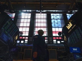 FILE - Traders work on the floor at the New York Stock Exchange in New York, Friday, July 1, 2022.