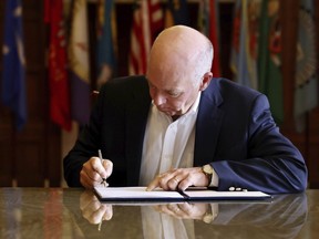 FILE - In this photo provided by the Montana Governor's Office, Republican Gov. Greg Gianforte signs a law banning TikTok in the state, May 17, 2023, in Helena, Mont. TikTok, Inc., filed a lawsuit Monday, May 22, 2023, seeking to overturn Montana's first-in-the-nation ban on the video sharing app, arguing the law is an unconstitutional violation of free speech rights and is based on "unfounded speculation" that the Chinese government could access users' data.