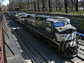FILE - A Norfolk Southern freight train rolls through downtown Pittsburgh, on March 26, 2018. The union that represents railroad engineers finally secured its first deal for paid sick time with Norfolk Southern several months after other rail unions began reaching similar agreements with the major freight railroads. The Brotherhood of Locomotive Engineers and Trainmen announced the deal with the railroad Thursday, May 18, 2023.
