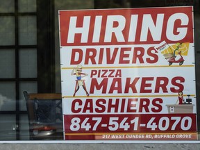 A hiring sign is displayed at a restaurant in Buffalo Grove, Ill., Wednesday, May 10, 2023. On Wednesday, the Labor Department reports on job openings and labor turnover for April.