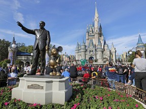 FILE - A statue of Walt Disney and Micky Mouse stands in front of the Cinderella Castle at the Magic Kingdom at Walt Disney World in Lake Buena Vista, Fla., Jan. 9, 2019. It's going on six months since Bob Iger returned to The Walt Disney Co., and while there's been plenty of issues to keep him busy, one has definitely been top of mind: reconnecting with the Disney theme park die-hards and restoring their faith in the brand.