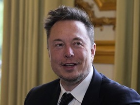 FILE - Elon Musk poses prior to his talks with French President Emmanuel Macron, May 15, 2023 at the Elysee Palace in Paris. A federal appeals court says Musk cannot back out of a settlement with securities regulators over 2018 tweets claiming he had the funding to take Tesla private. The 2nd U.S. Circuit Court of Appeals in Manhattan ruled Monday, May 15, 2023 just days after hearing arguments from lawyers in the case.