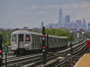 FILE - A subway approaches an above ground station in the Brooklyn borough of New York with the New York City skyline in the background, June 21, 2017. The transit authority that runs subways, commuter trains and buses in New York City is giving up on a system that sent automated alerts about service disruptions through Twitter. The Metropolitan Transportation Authority decided to stop using Twitter for service alerts Thursday, April 27, 2023.
