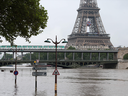 A subway train crosses a bridge over the River Seine in front of Paris's Eiffel Tower.