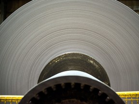 A finished roll of newsprint paper, weighing close to four tons, sits on the production line at the Resolute Forest Products mill in Thunder Bay, Ont.