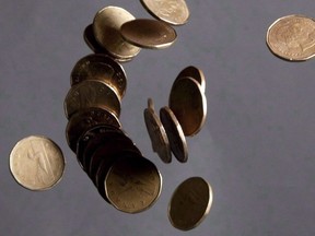 Falling Canadian loonies are pictured in Vancouver on September 22, 2011. Canada's housing agency says the country has the highest level of household debt in the G7, making its economy vulnerable to a global economic crisis.