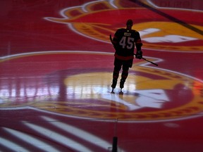 Ottawa Senators left wing Parker Kelly (45) skates as projections of the team's logo spin on the ice before an NHL game against the Boston Bruins in Ottawa, on Tuesday, Oct. 18, 2022. A celebrity bidding war for a minority ownership stake in the Senators stands to lift the team's profile to new heights, while serving as a safe way for stars to park their money.